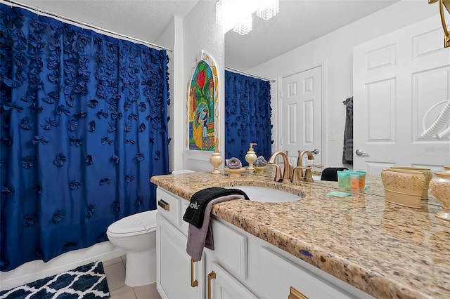 2624 Daulby St, Kissimmee, FL 34747 - full bathroom featuring tile patterned floors, toilet, vanity, and a textured ceiling