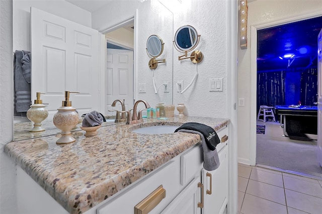 2624 Daulby St, Kissimmee, FL 34747 - bathroom with tile patterned floors, vanity, and a textured wall