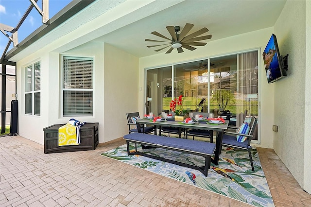 2624 Daulby St, Kissimmee, FL 34747 - view of patio / terrace featuring ceiling fan, outdoor dining area, and glass enclosure