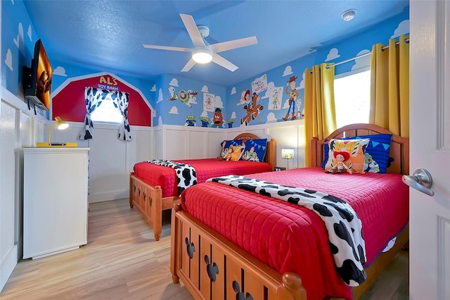 2624 Daulby St, Kissimmee, FL 34747 - bedroom with light wood-style flooring, wainscoting, and a ceiling fan