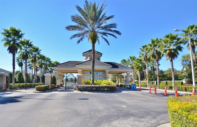 2624 Daulby St, Kissimmee, FL 34747 - view of asphalt road with a gate, street lights, and a gated entry