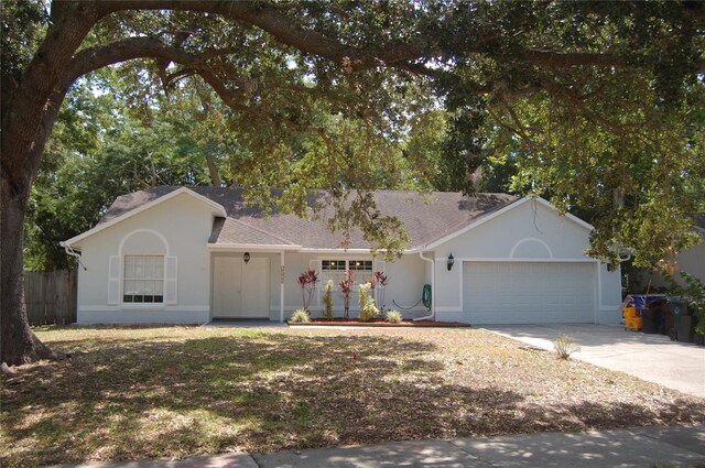 1644 Cypress Woods Cir, Saint Cloud, FL 34772 - ranch-style house featuring concrete driveway, an attached garage, stucco siding, and fence