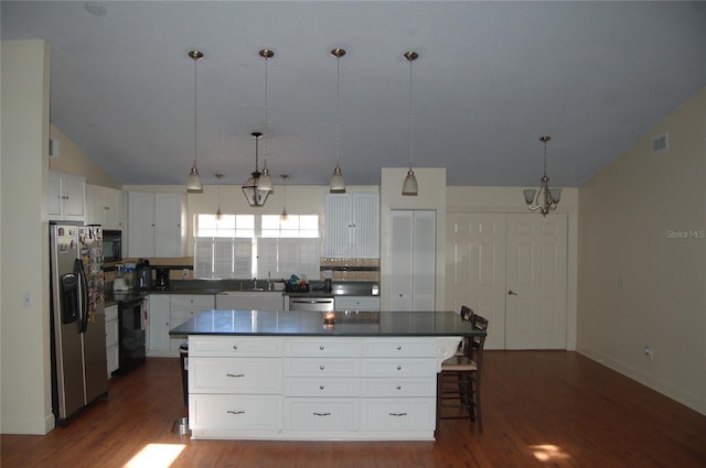 1644 Cypress Woods Cir, Saint Cloud, FL 34772 - kitchen with dark countertops, visible vents, black appliances, and dark wood-type flooring