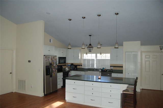 1644 Cypress Woods Cir, Saint Cloud, FL 34772 - kitchen featuring visible vents, dark wood-type flooring, black appliances, dark countertops, and white cabinets