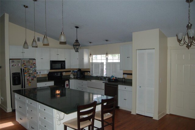 1644 Cypress Woods Cir, Saint Cloud, FL 34772 - kitchen with dark countertops, white cabinetry, black appliances, and a sink