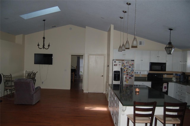 1644 Cypress Woods Cir, Saint Cloud, FL 34772 - kitchen featuring dark countertops, a skylight, black appliances, and high vaulted ceiling