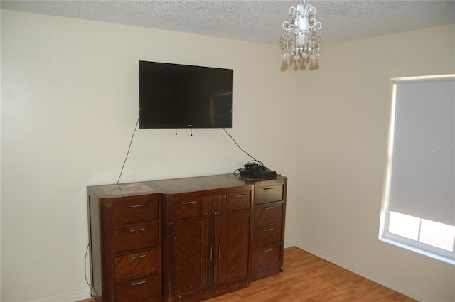 1644 Cypress Woods Cir, Saint Cloud, FL 34772 - interior details with baseboards, a notable chandelier, a textured ceiling, and wood finished floors
