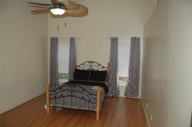 1644 Cypress Woods Cir, Saint Cloud, FL 34772 - bedroom featuring ceiling fan, baseboards, multiple windows, and wood finished floors