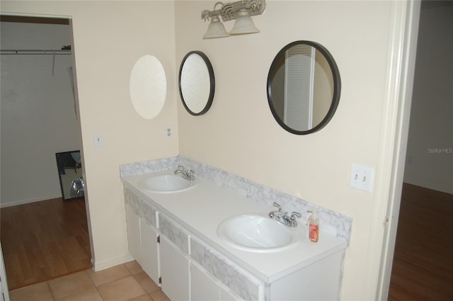 1644 Cypress Woods Cir, Saint Cloud, FL 34772 - full bathroom with double vanity, wood finished floors, and a sink