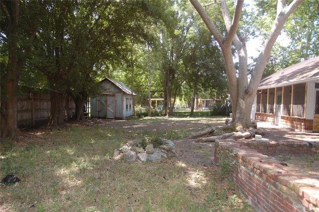 1644 Cypress Woods Cir, Saint Cloud, FL 34772 - view of yard with a storage shed, a sunroom, fence, and an outbuilding