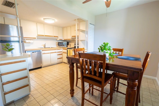 kitchen featuring a sink, visible vents, light countertops, light tile patterned floors, and appliances with stainless steel finishes