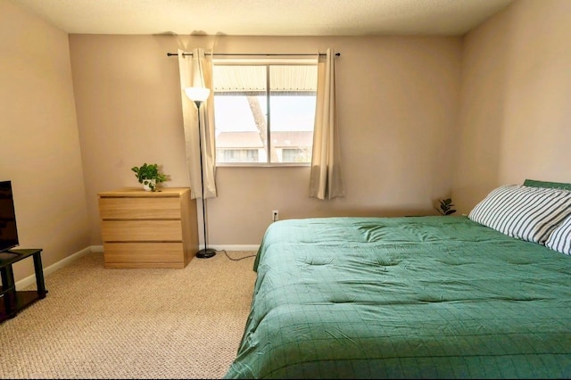 bedroom featuring carpet and baseboards