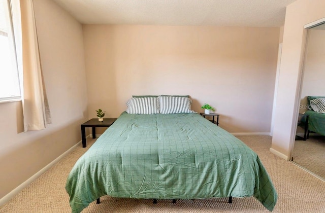 carpeted bedroom with baseboards