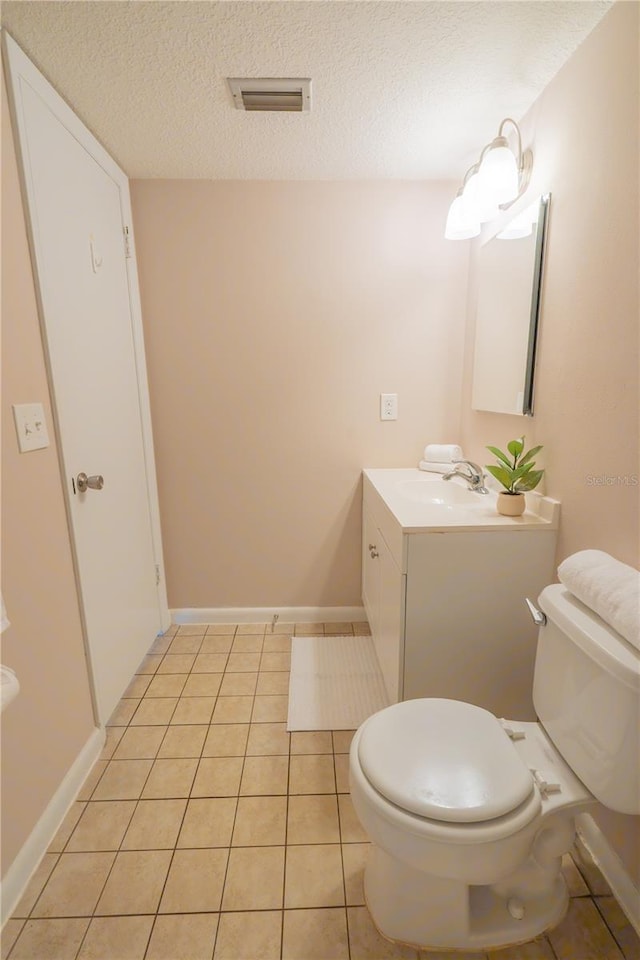 half bath featuring a textured ceiling, toilet, visible vents, tile patterned floors, and vanity