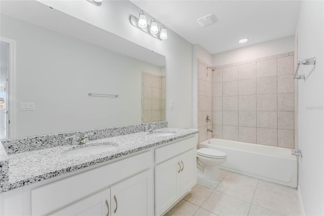 full bath with a sink, double vanity, toilet, and tile patterned floors