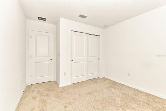 4792 Vellacito Way, Davenport, FL 33897 - unfurnished bedroom featuring light colored carpet, baseboards, a closet, and visible vents