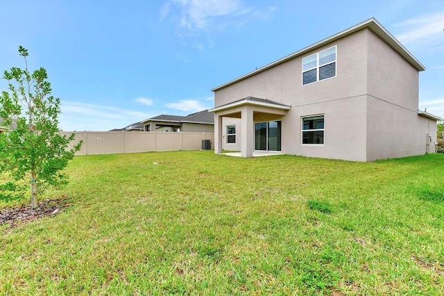 4792 Vellacito Way, Davenport, FL 33897 - rear view of house with a yard, stucco siding, fence, and central AC
