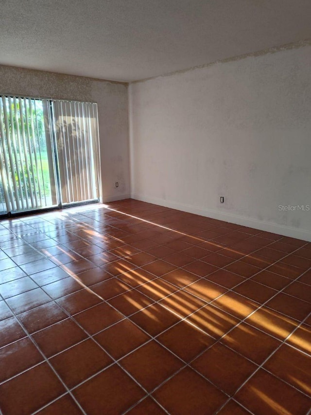 1508 Virginia Ave Unit 105, Daytona Beach, FL 32114 - unfurnished room with baseboards and dark tile patterned flooring