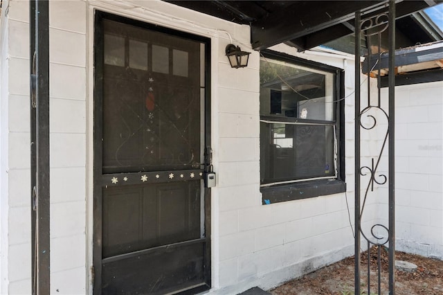 property entrance featuring concrete block siding