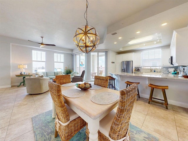 5 Riverwalk Dr Unit 601, New Smyrna Beach, FL 32169 - dining area featuring healthy amount of natural light, a raised ceiling, light tile patterned flooring, a chandelier, and recessed lighting