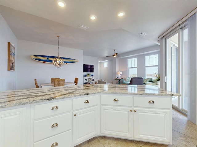 5 Riverwalk Dr Unit 601, New Smyrna Beach, FL 32169 - kitchen featuring a ceiling fan, light stone countertops, light tile patterned floors, white cabinets, and recessed lighting