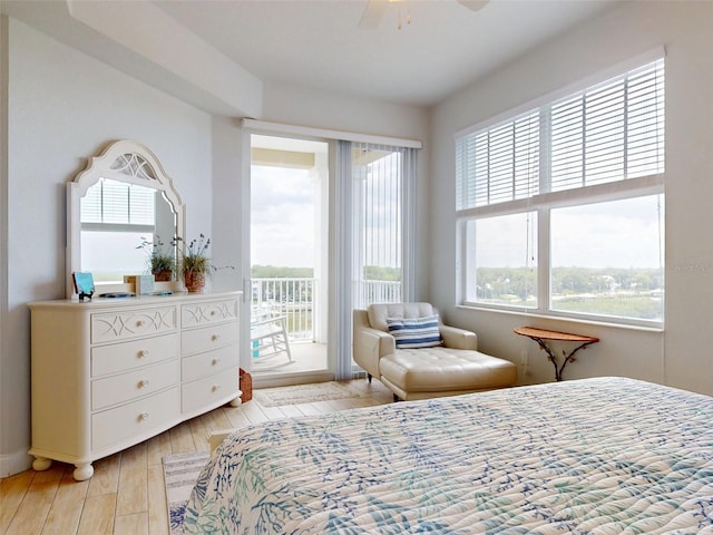5 Riverwalk Dr Unit 601, New Smyrna Beach, FL 32169 - bedroom with access to outside, baseboards, ceiling fan, and light wood finished floors