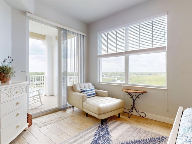 5 Riverwalk Dr Unit 601, New Smyrna Beach, FL 32169 - living area with healthy amount of natural light, wood finished floors, and baseboards