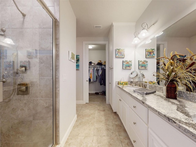 5 Riverwalk Dr Unit 601, New Smyrna Beach, FL 32169 - bathroom featuring a stall shower, vanity, tile patterned floors, a spacious closet, and baseboards
