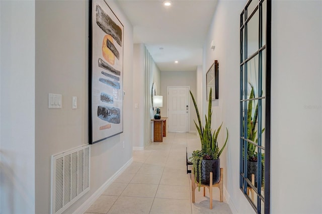 hallway with light tile patterned floors, visible vents, baseboards, and recessed lighting