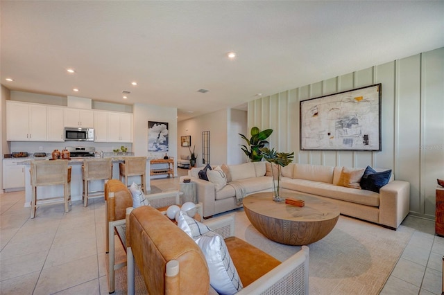 living room featuring visible vents, light tile patterned floors, and recessed lighting