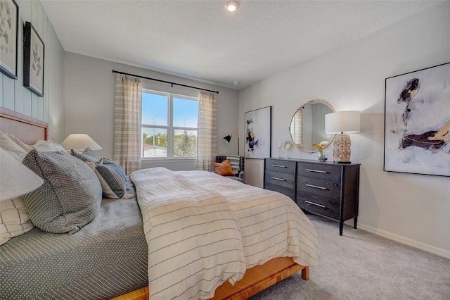 bedroom featuring light colored carpet and baseboards