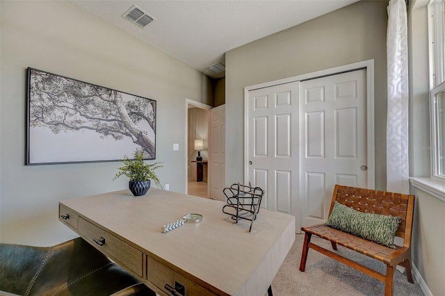 home office featuring visible vents and light carpet