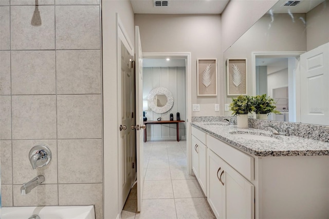 bathroom with a sink, tile patterned flooring, shower / washtub combination, and double vanity