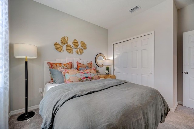 bedroom with light colored carpet, baseboards, a closet, and visible vents