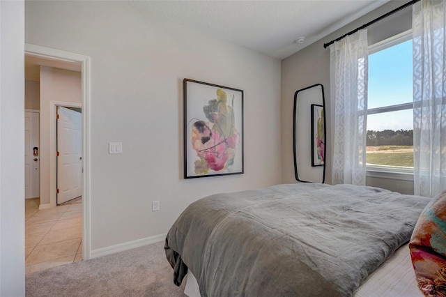 tiled bedroom with carpet and baseboards