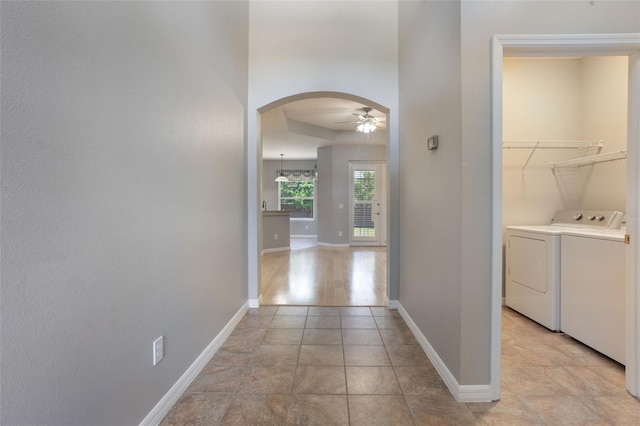 3436 Gerber Daisy Ln, Oviedo, FL 32766 - hallway with arched walkways, baseboards, and washer and clothes dryer