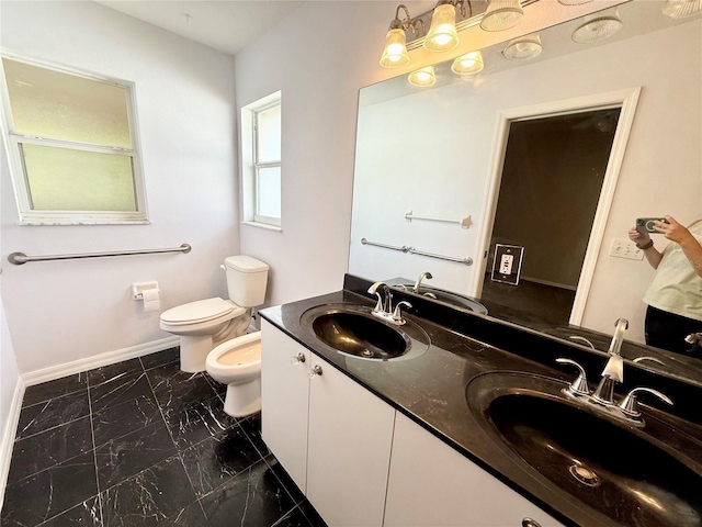 bathroom with a bidet, toilet, marble finish floor, and a sink