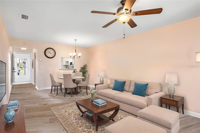 1348 Myerlee Gardens Ave, Fort Myers, FL 33919 - living area with a chandelier, baseboards, a ceiling fan, and light wood-type flooring