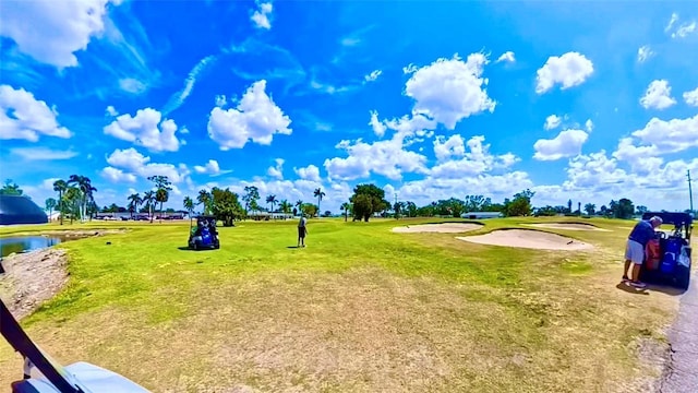 1348 Myerlee Gardens Ave, Fort Myers, FL 33919 - surrounding community with golf course view, a lawn, and a water view