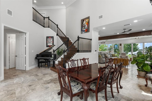 dining room featuring a high ceiling, a ceiling fan, recessed lighting, baseboards, and ornamental molding
