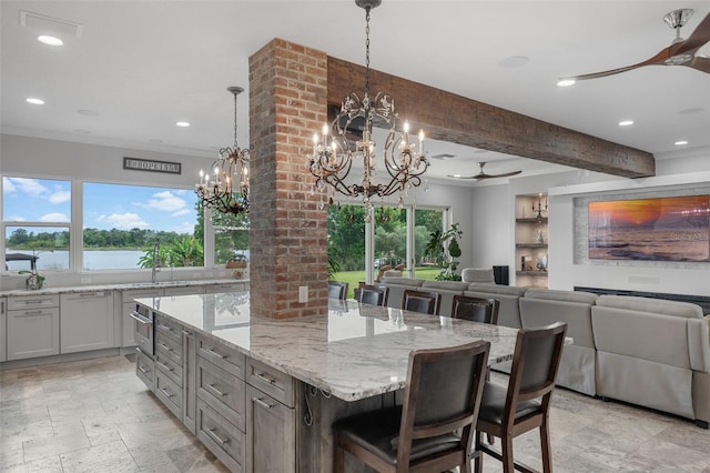 kitchen with ceiling fan, a chandelier, healthy amount of natural light, a center island, and recessed lighting