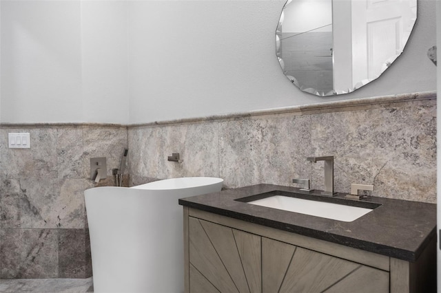full bath with vanity and a wainscoted wall