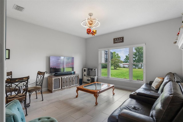 living area featuring a chandelier and light wood-style floors