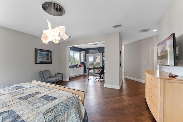 bedroom with dark wood-type flooring, baseboards, and a textured ceiling