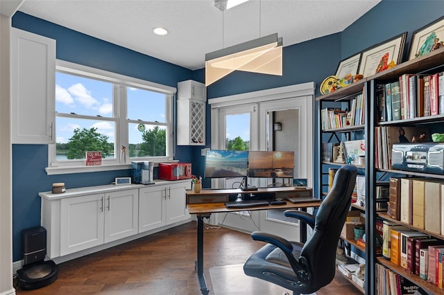 office with healthy amount of natural light, dark wood finished floors, and recessed lighting
