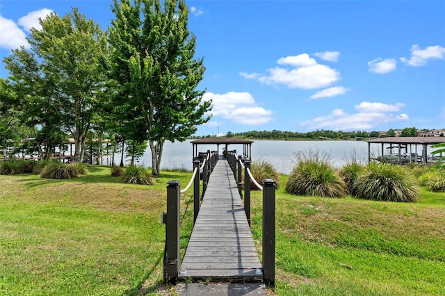 dock area featuring a yard and a water view