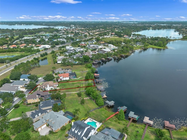 aerial view of residential area featuring a nearby body of water and property boundaries highlighted