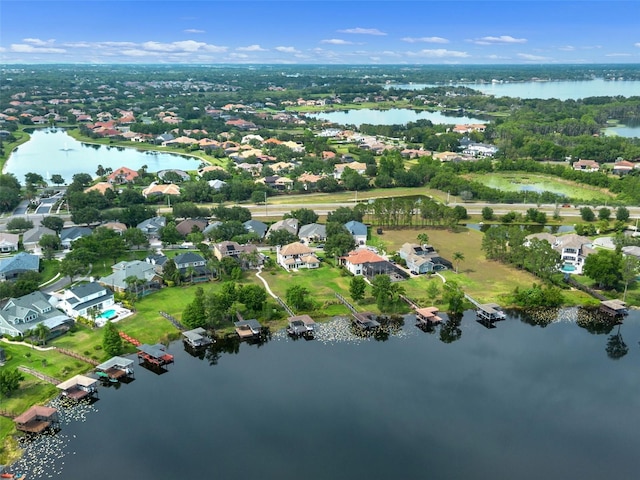 aerial view of property's location with a large body of water and nearby suburban area