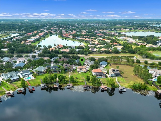 aerial view of property and surrounding area featuring a large body of water and nearby suburban area