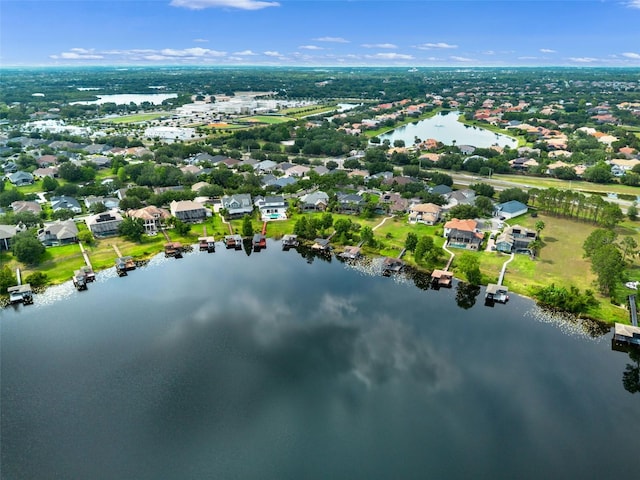 view of property location with a large body of water, nearby suburban area, and property boundaries highlighted